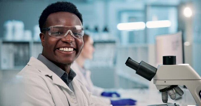 Black man, scientist and forensic with microscope for research, new discovery or examination at laboratory. Face of young African, male person or biologist with smile for science or test at lab