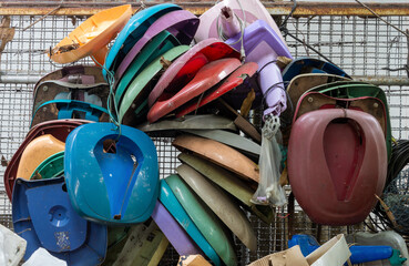 Old used parts hang on a fence in a fan repair workshop, Thailand
