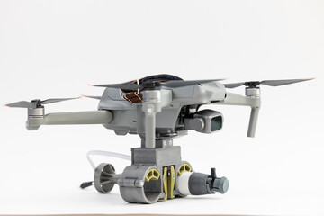 Engineering development for war, army drone with mechanism for dropping grenades on white isolated background. Concept military UAVs using in weapon