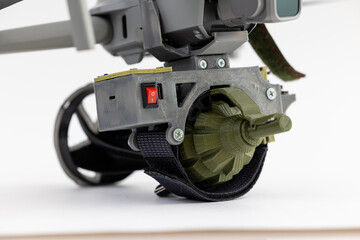 Engineering development for war, mechanism for dropping grenades from army drone on white isolated background. Concept military UAVs using in weapon