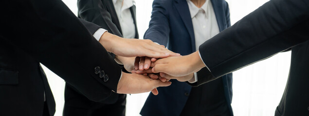 Office worker team stacking hand together symbolize successful group of business partnership and...
