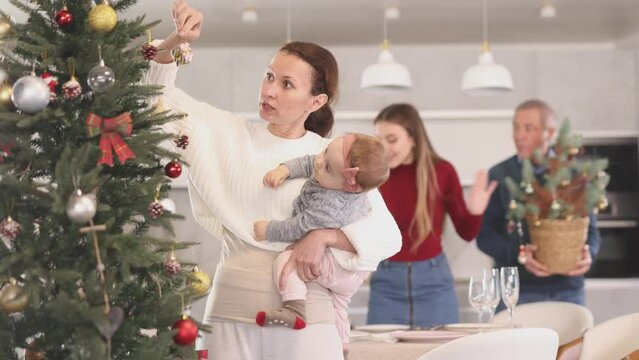 Woman decorating Christmas tree, family preparing for Christmas. Woman decorating Christmas tree. High quality 4k footage