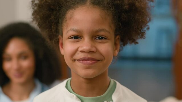 Close up face African American child little girl smile laughter childish healthcare home kid daughter female offspring medicare expression wellbeing parenting happy ethnic portrait innocence enjoying