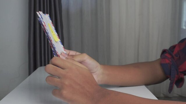 side view high angle of hands sorting envelopes on table