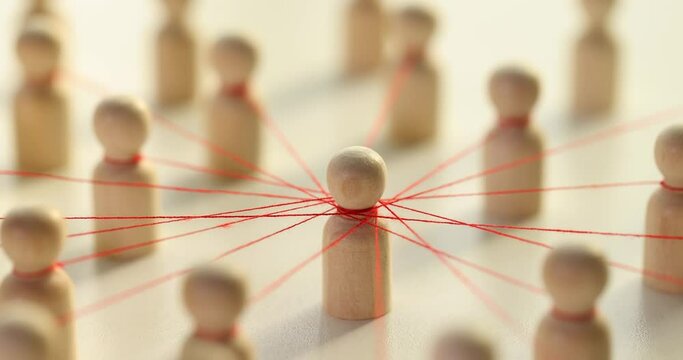 Wooden figures of people tied with red threads