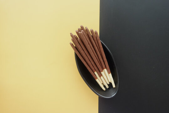Chocolate Biscuit Sticks on a Stylish Black and Yellow Background, Ideal for Food Photography