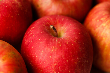 Ripe organic red apple on wooden table background.