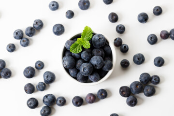 Ripe organic blueberries on white wooden table background. Selective focus.