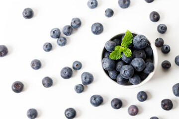 Ripe organic blueberries on white wooden table background. Selective focus.