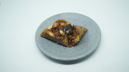 Traditional wrapped rice dumpling or zongzi on a plate