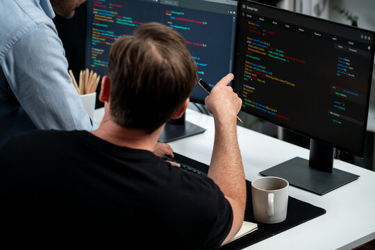IT developers discussing online software development information on pc screen, creating program coding for latest version application on website. Concept of brainstorming firmware updated. Sellable.