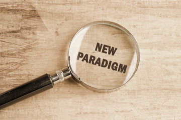 New paradigm motivational phrase through a magnifying glass on papyrus