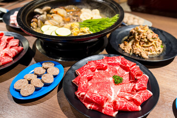 Hotpot with fresh slice of meat and seafood in restaurant