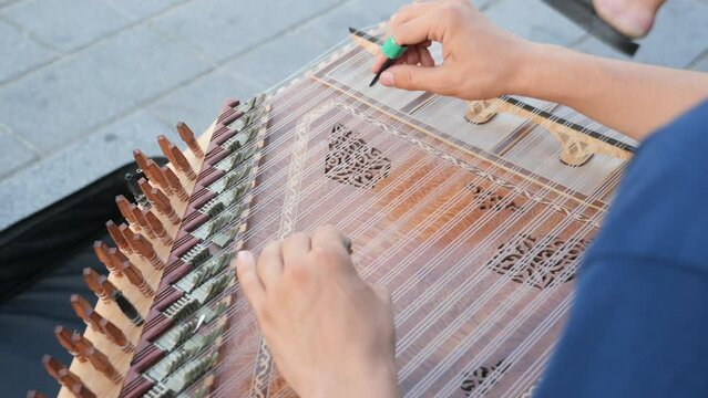 hands of musician playing on cimbalom or dulcimer, 