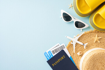 Flat lay composition of summer travel essentials including sunglasses, hat, passport, boarding...