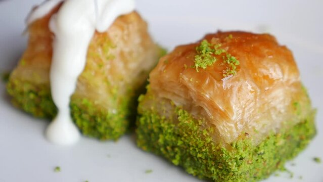  pouring cream on handmade turkish dessert baklava 