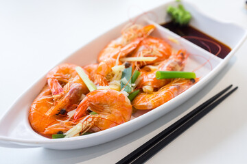 Steamed shrimp with green onion and garlic on the dish
