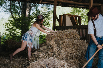 A young couple working together in a barn, stacking hay bales. They are enjoying a rustic farm...
