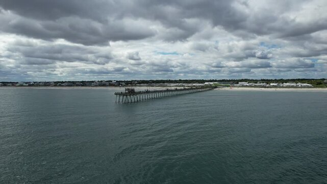 Slowly flying away drone shot from the Bogue Inlet Pier, Emerald Isle NC