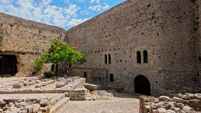 Zoom in shot of Medieval Chlemoutsi castle in Kastro village, Peloponnese, Kyllini-Andravida, Greece on a sunny day.