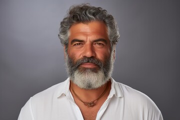 Obraz premium A man with a beard and a white shirt is smiling