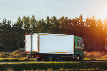White delivery truck driving through rural area