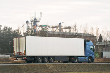 White delivery truck driving through rural area