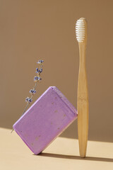 Eco friendly bamboo toothbrush and Handmade aromatic spa lavender soap. Natural additives and extracts. Bar of lavender soap with dried flowers. Beauty treatment product herbal ecological organic