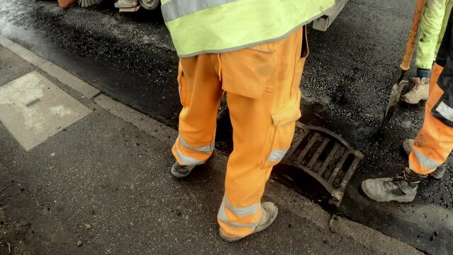Worker clean street drain to prevent flooding