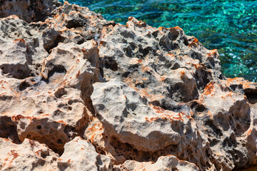Rugged rocky coast and turquoise sea background