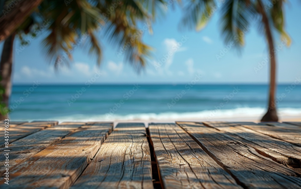 Poster a wooden table with a view of the ocean and palm trees. the table is empty and the view is serene an