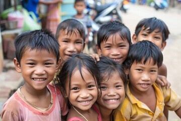 Group of asian children smiling at the camera in the street.