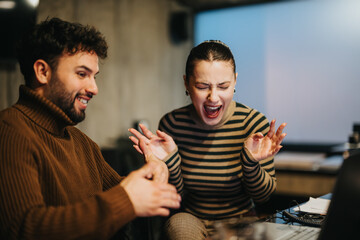 Young business people in a corporate office, analyzing data, discussing marketing strategies, and planning project development late at night.