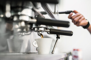 Espresso machine pouring fresh black coffee, close up.