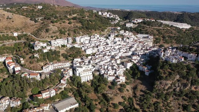 Spectacular view from drone of old white-washed houses of clifftop village of Casares at sunny day, Spain
