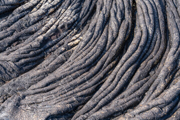 Pāhoehoe (also spelled pahoehoe, from Hawaiian meaning "smooth, unbroken lava") is basaltic lava that has a smooth, billowy, undulating, or ropy surface. Alanui Kahiko, Hawaii Volcanoes National Park
