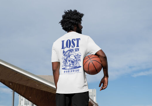 Mockup of man wearing customized t-shirt holding basketball