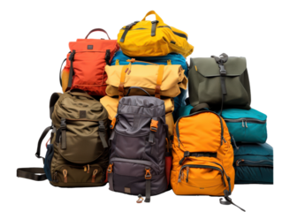 A pile of backpacks and bags of various colors and sizes