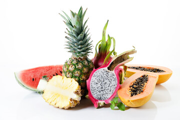 Creative layout made of fruits. Watermelon, pineapple, dragon fruit and papaya on white background.