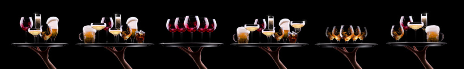 Hand holding tray with different alcohol cocktails isolated on black background