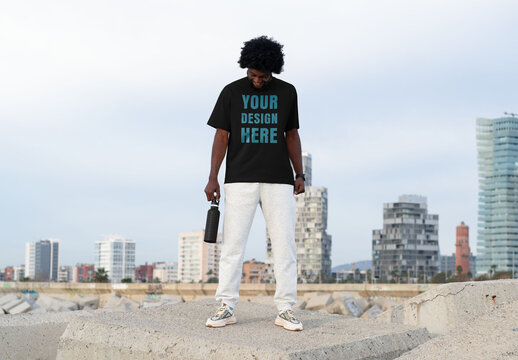 Mockup of man wearing customizable t-shirt, looking down