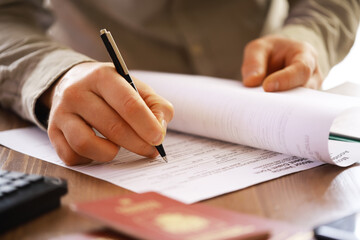 Businessman Signing Important Document - Close-up of Hand with Pen Signing Paperwork