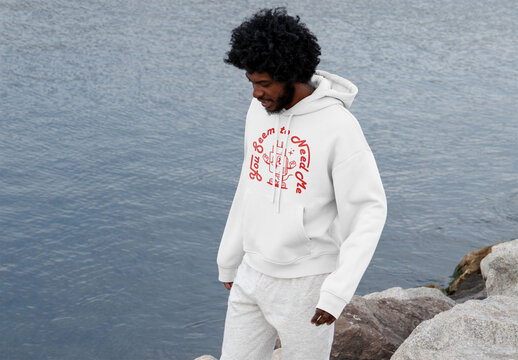 Mockup of man wearing customizable hoodie by water