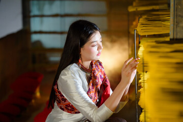 teenage girl dressed in traditional Thai clothing