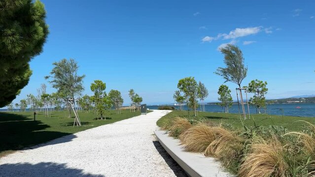 A park with a path and a bench. 