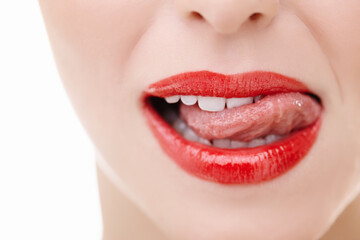 Obraz premium Mouth, woman and tongue out for makeup in studio with red lipstick, cosmetics and teeth. Female model, lips and results or aesthetic by white background for luxury, glow and product or treatment