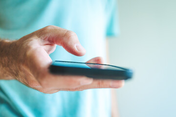 Closeup of adult caucasian male hand using mobile phone device, communication technology and social media concept