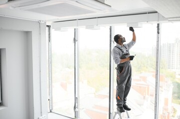 African HVAC Technician Worker Testing Newly Installed Ventilation System. Commercial Heating, Cooling and Air Ventilation Systems