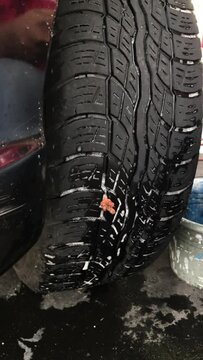 Mechanic Checking Tire for Leaks