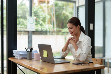 Beautiful asian businesswoman Confident working with a laptop, typing, small business owner online...
